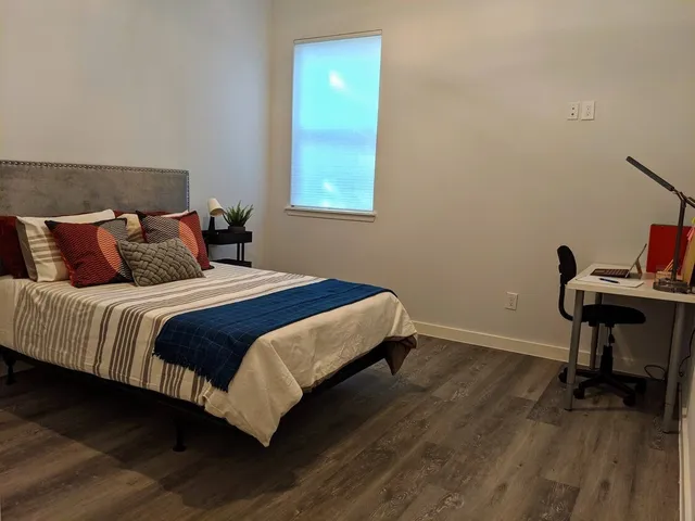 a bedroom with a bed and a table