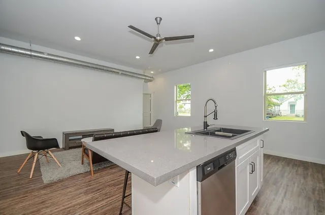 a kitchen with a sink a counter space and a window
