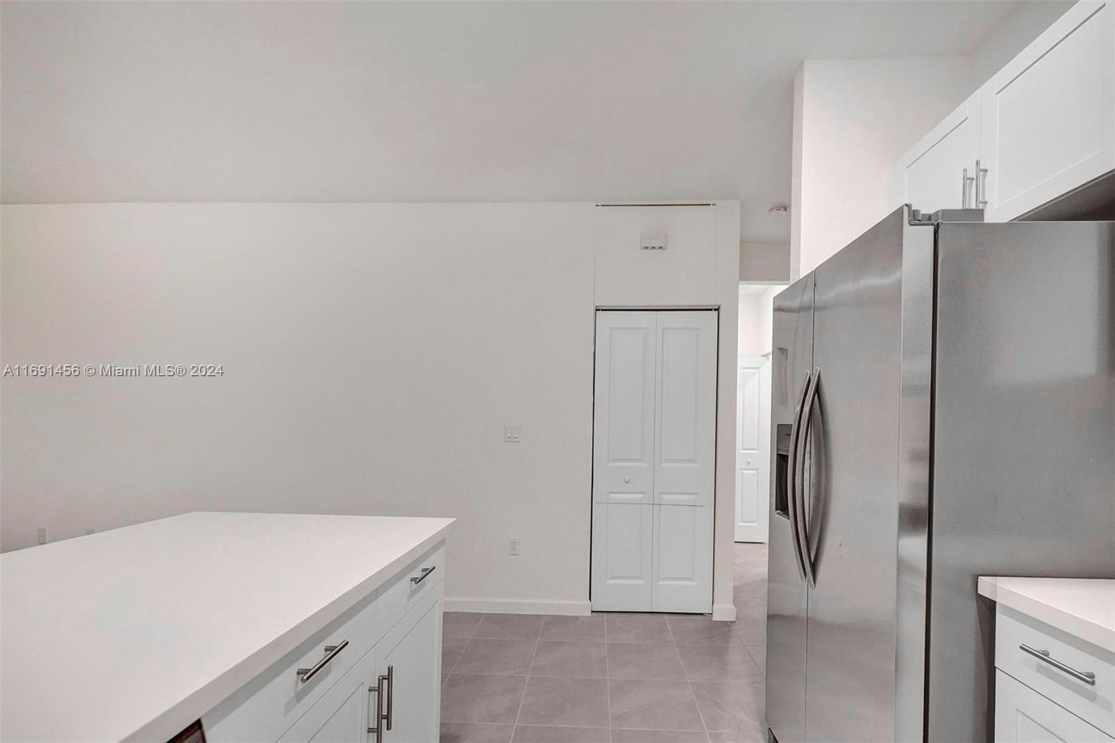 13405 Southwest 285th Street, Unit 13405 Homestead, FL 33033 - Photo 41 of 59 a room with a white cabinets and a refrigerator