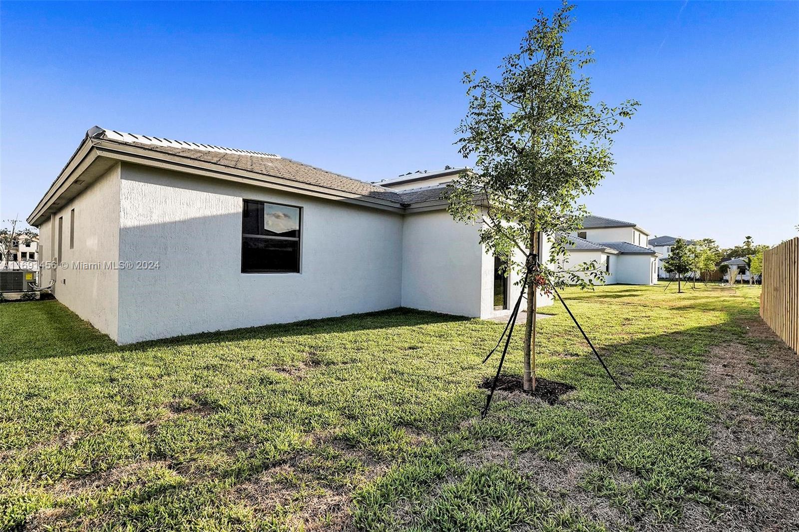 13405 Southwest 285th Street, Unit 13405 Homestead, FL 33033 - Photo 55 of 59 a house with a yard