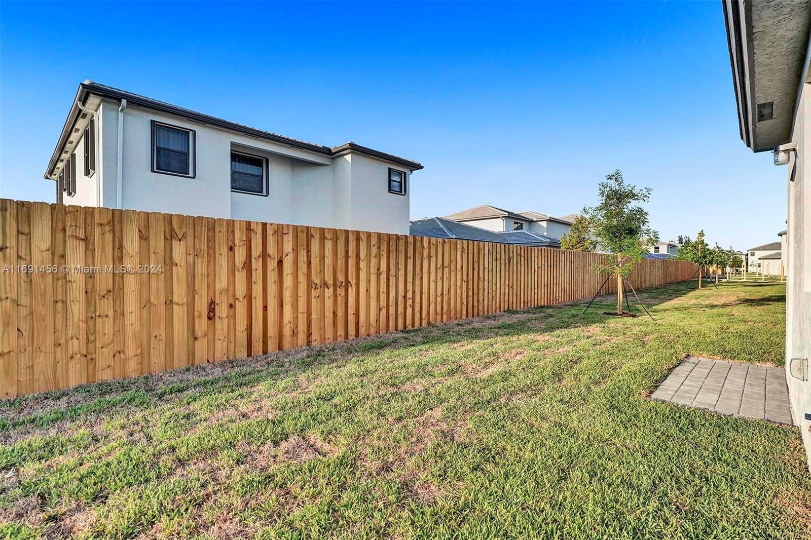 13405 Southwest 285th Street, Unit 13405 Homestead, FL 33033 - Photo 58 of 59 a view of a backyard with wooden fence