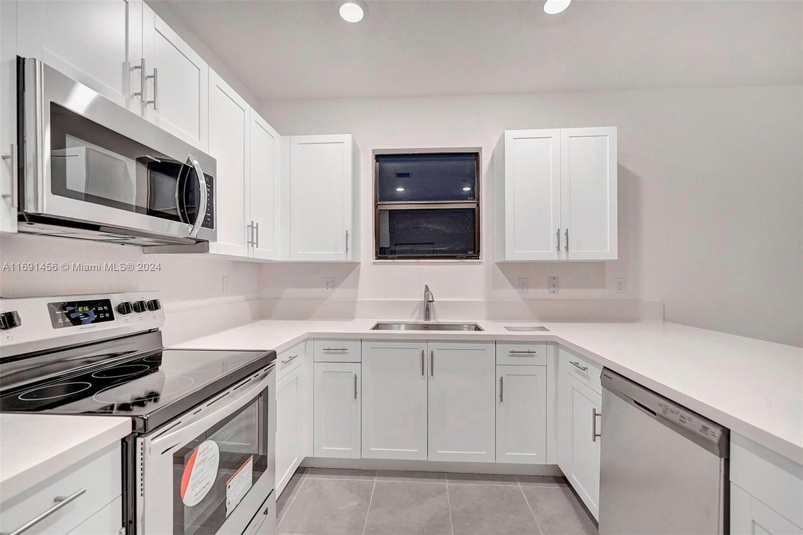 13405 Southwest 285th Street, Unit 13405 Homestead, FL 33033 - Photo 6 of 59 a kitchen with cabinets stainless steel appliances and sink