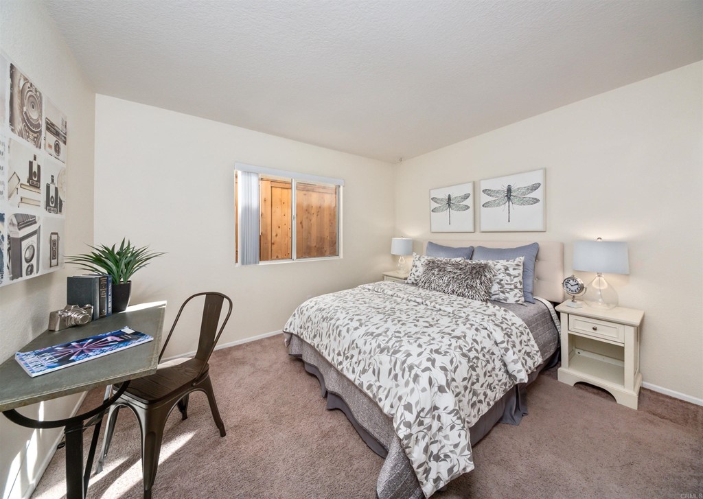 1593 Dawson Drive Vista, CA 92081 - Photo 18 of 40 a bedroom with a bed and a chair