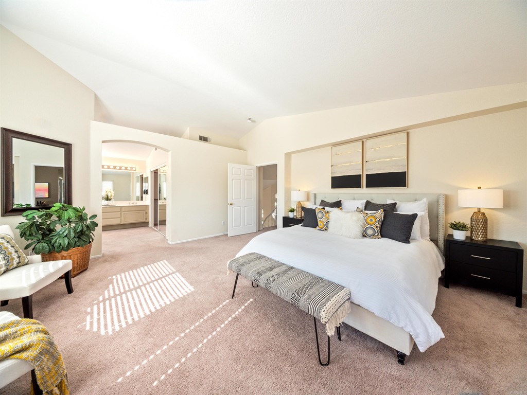 1593 Dawson Drive Vista, CA 92081 - Photo 24 of 40 a spacious bedroom with a bed and a couch