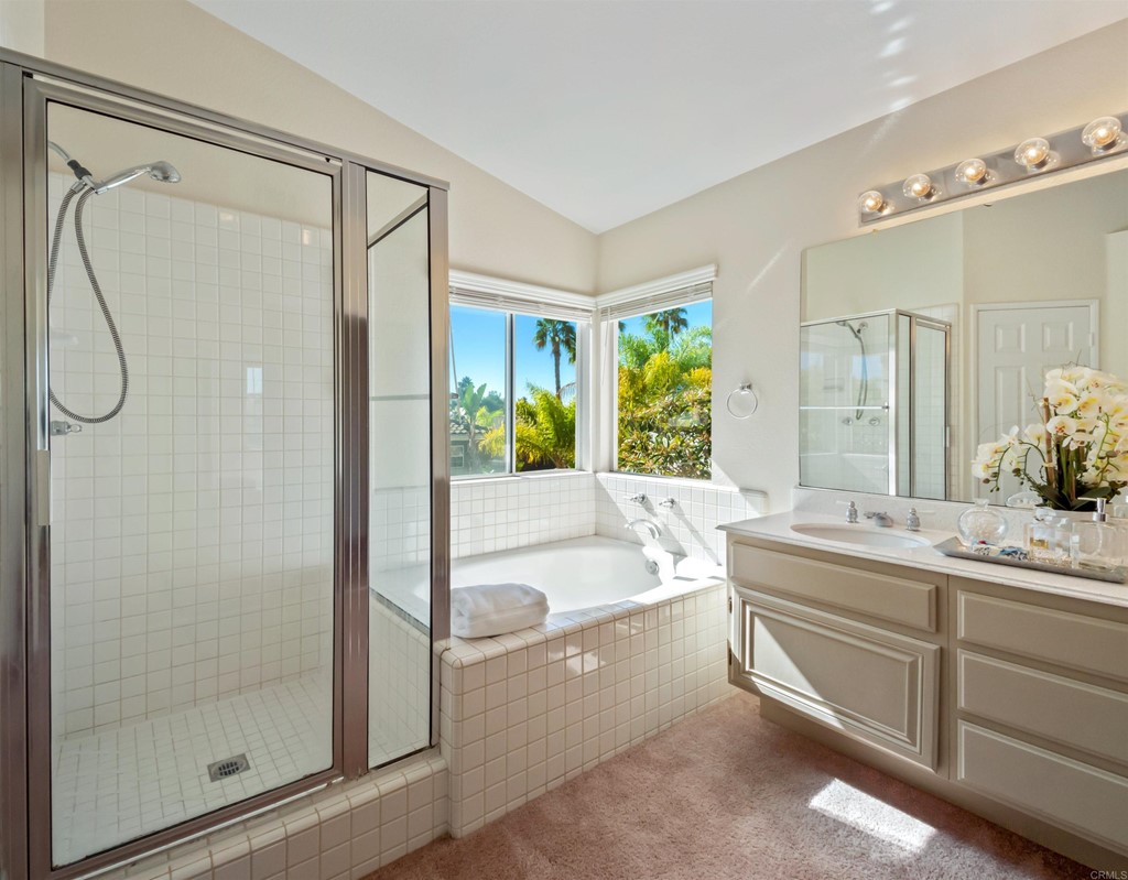 1593 Dawson Drive Vista, CA 92081 - Photo 29 of 40 a bathroom with a granite countertop sink a mirror and a bathtub