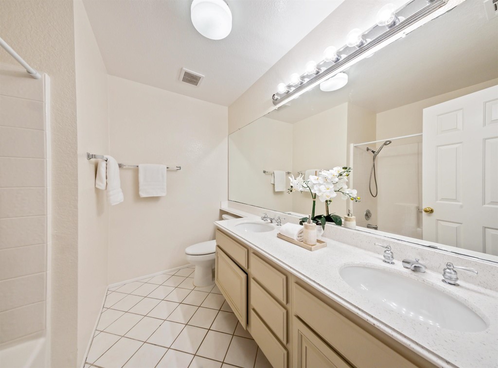 1593 Dawson Drive Vista, CA 92081 - Photo 33 of 40 a spacious bathroom with a double vanity sink and a mirror