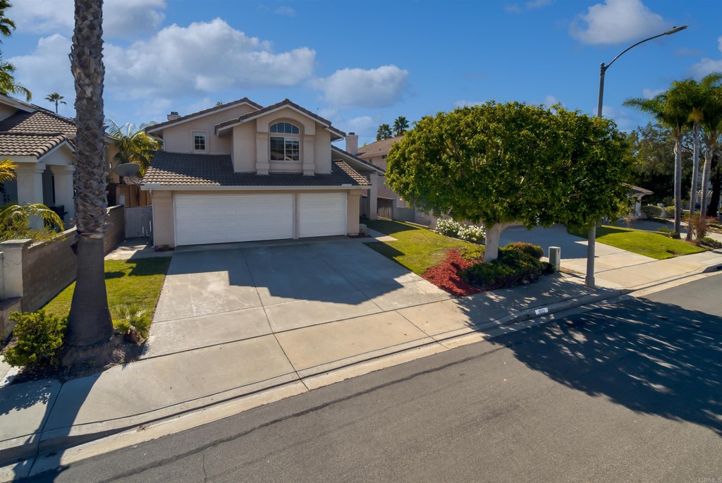 1593 Dawson Drive Vista, CA 92081 - Photo 37 of 40 a front view of a house with a yard and garage