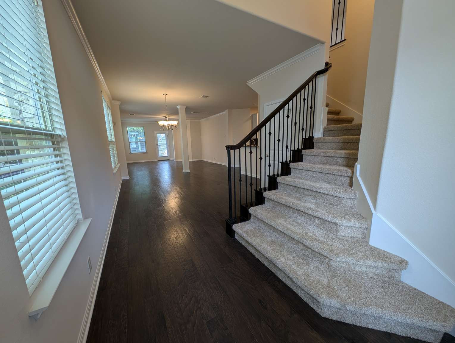 7301 Bandera Ranch Trail, Unit A Austin, TX 78750 - Photo 3 of 20 An inviting entry foyer transitions seamlessly to living areas, featuring a grand carpeted staircase and rich hardwood flooring.