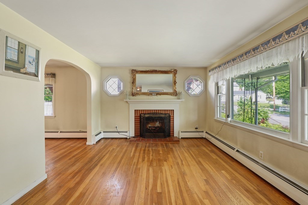 8 Hillsboro Road Worcester, MA 01605 - Photo 5 of 37 wooden floor fireplace and windows in an empty room