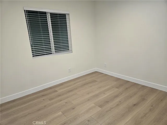 an empty room with wooden floor