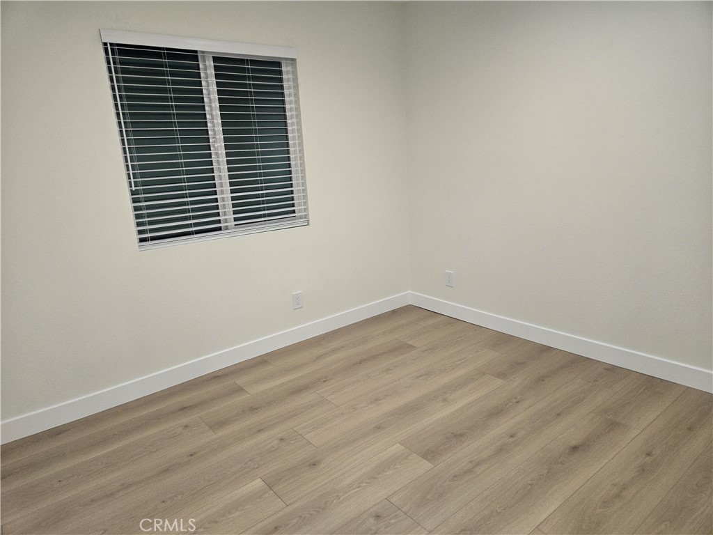 8712 Oceanview Avenue, Unit B Orange, CA 92865 - Photo 6 of 9 an empty room with wooden floor
