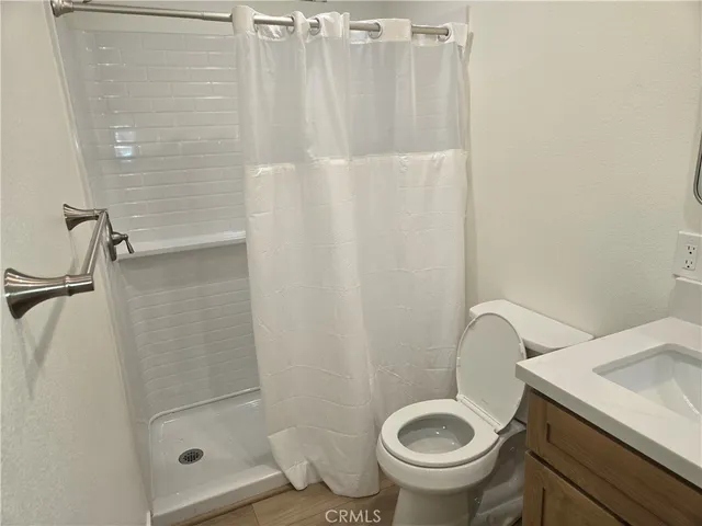 a bathroom with a toilet and a shower