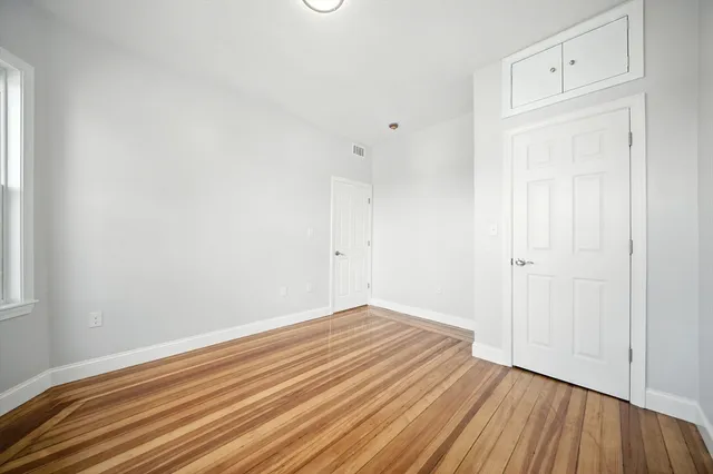 a view of room with wooden floor