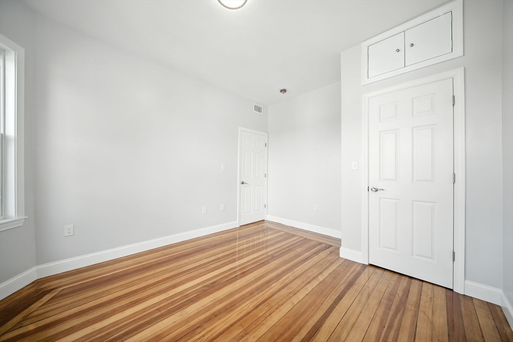 155 Wellington Hill Street, Unit 3 Boston, MA 02126 - Photo 12 of 20 a view of room with wooden floor