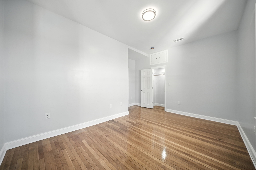 155 Wellington Hill Street, Unit 3 Boston, MA 02126 - Photo 14 of 20 a view of an empty room with wooden floor