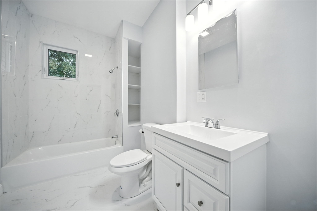 155 Wellington Hill Street, Unit 3 Boston, MA 02126 - Photo 16 of 20 a bathroom with a sink a toilet and shower