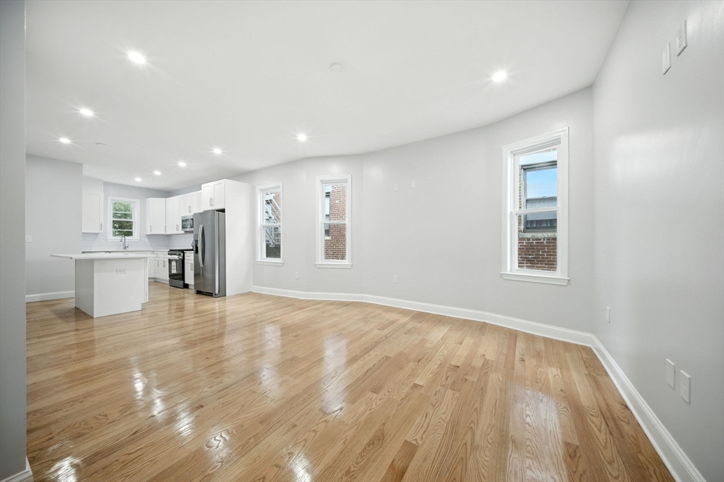 155 Wellington Hill Street, Unit 3 Boston, MA 02126 - Photo 6 of 20 a view of an empty room with wooden floor