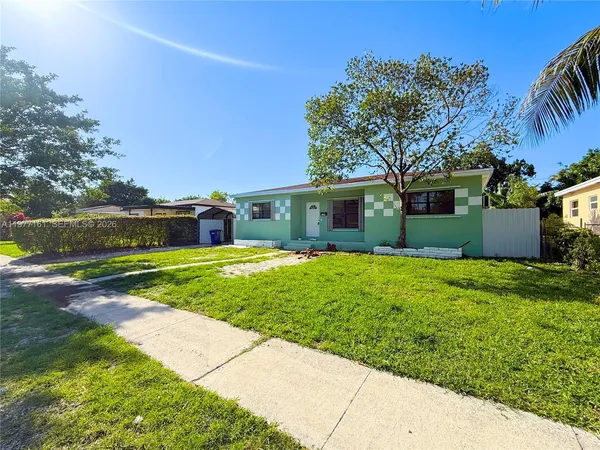 a front view of house with yard and green space