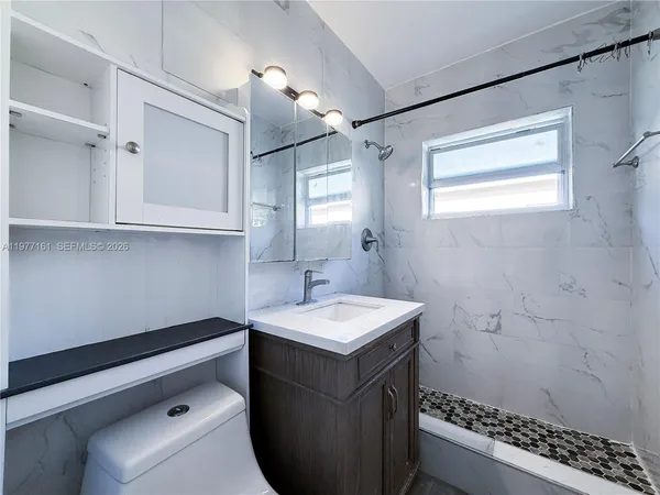 a bathroom with a sink a vanity and a mirror