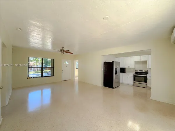 an empty room with windows and closet