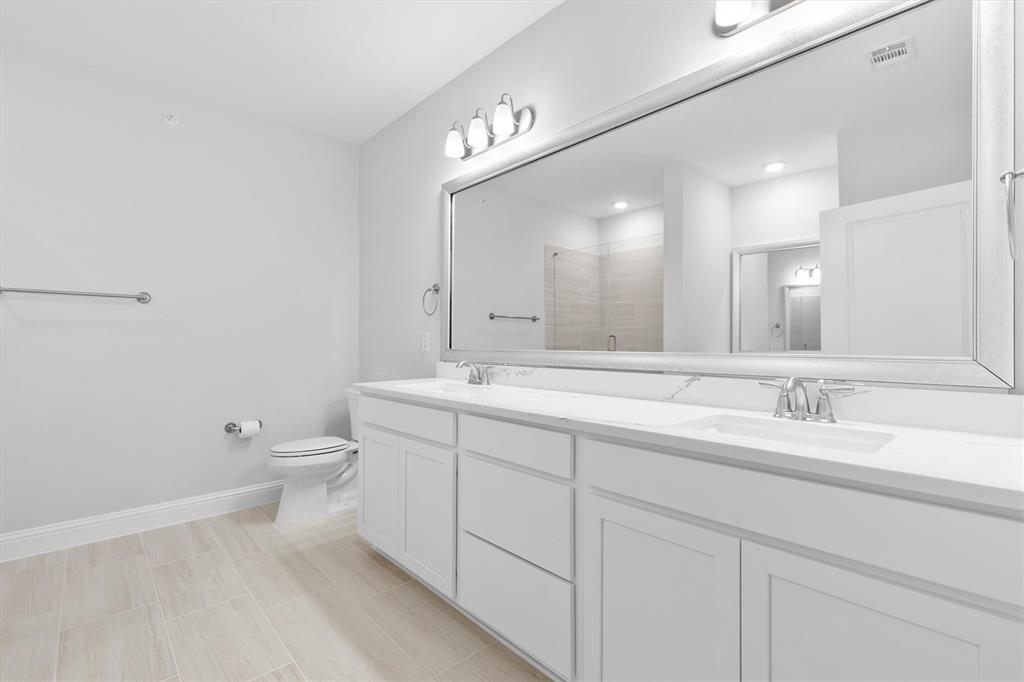 651 Watters Road, Unit 4403 Allen, TX 75013 - Photo 17 of 37 a bathroom with a double vanity sink and a mirror