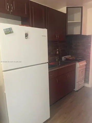 a white refrigerator freezer sitting inside of a kitchen