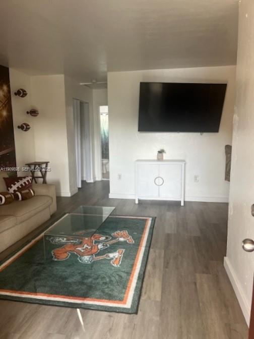 590 Northwest 64th Street, Unit A Miami, FL 33150 - Photo 4 of 6 a living room with flat screen tv