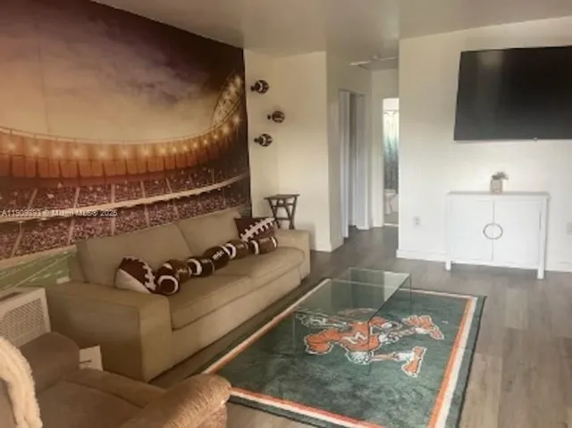 a living room with furniture and a flat screen tv