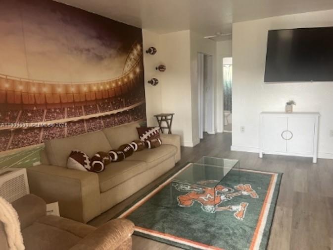 590 Northwest 64th Street, Unit A Miami, FL 33150 - Photo 6 of 6 a living room with furniture and a flat screen tv