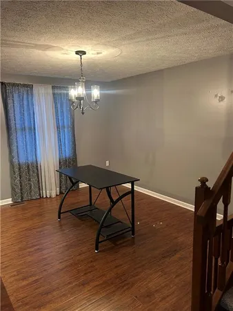 a view of a room with wooden floor and chair