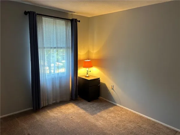 an empty room that has a bathroom in it