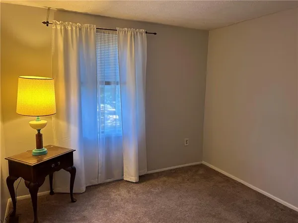 a bedroom with a bed and a mirror