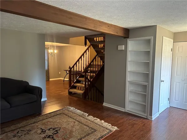 a view of entryway and hall with wooden floor