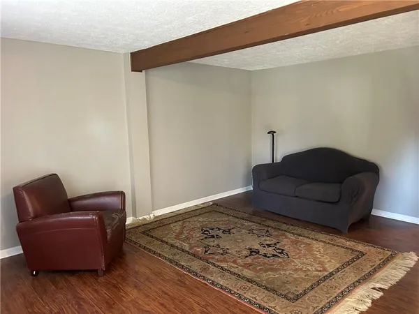 a living room with furniture and a rug