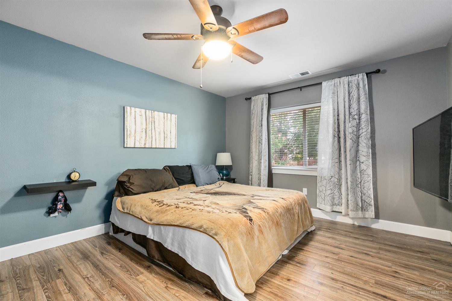 21335 Pecoraro Loop Bend, OR 97701 - Photo 14 of 24 Master bedroom with gas fireplace, lamin