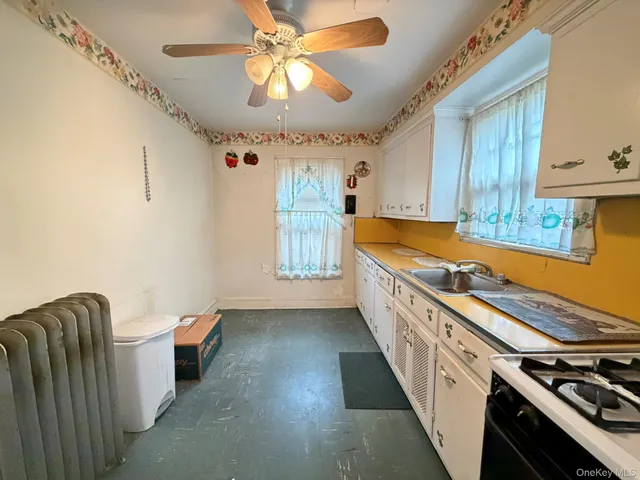 a kitchen with stainless steel appliances granite countertop a sink a stove and a refrigerator