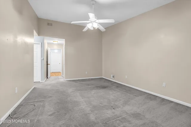 a spacious bathroom with a sink a toilet a mirror and bathtub