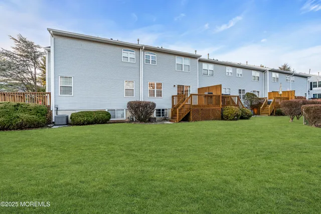 a view of a livingroom with a fireplace a chandelier and wooden floor