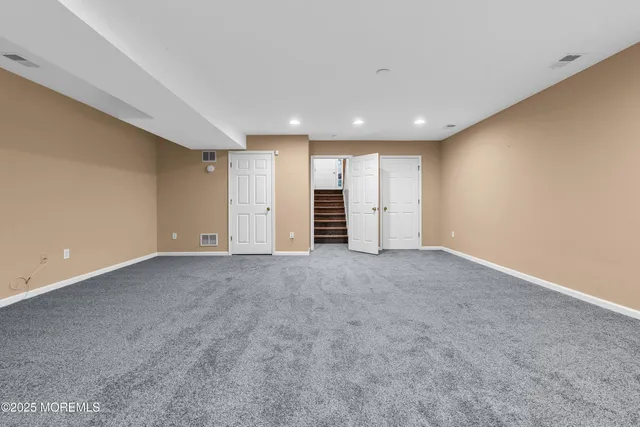 a living room with furniture a rug and a flat screen tv