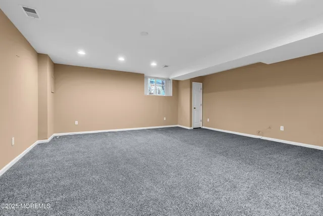 a view of empty room with wooden floor and fireplace