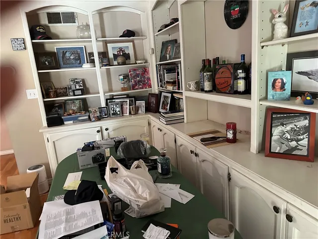 a kitchen with stainless steel appliances a sink a stove a dining table and chairs