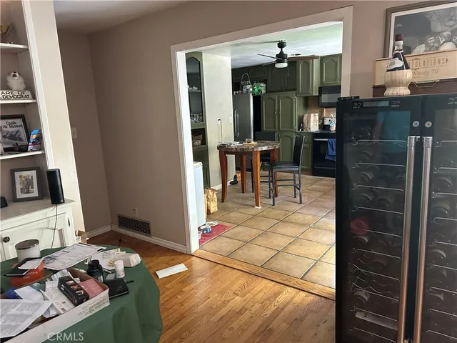 a living room with furniture a dining table and chairs with floor to ceiling window