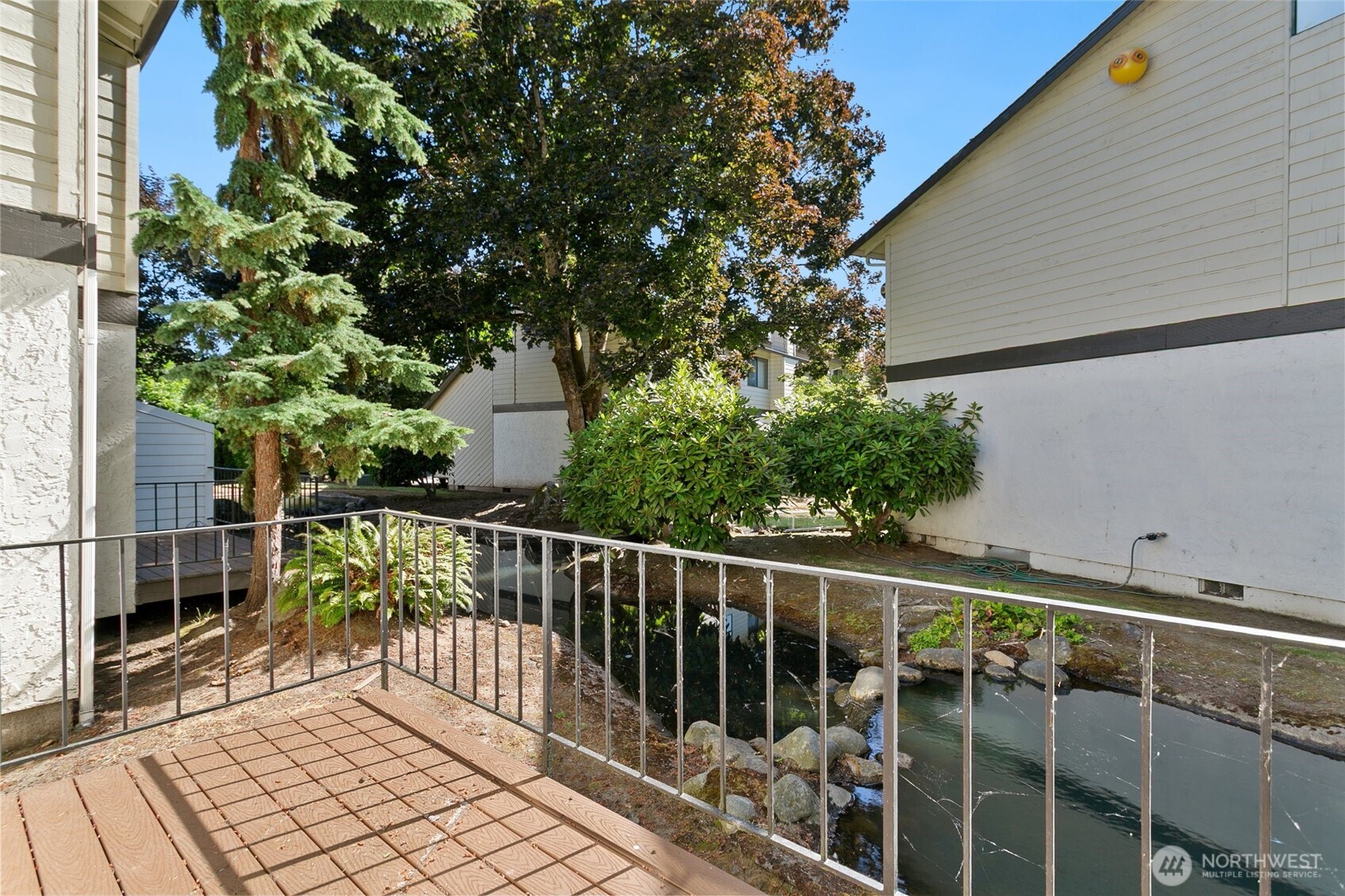 1802 Maple Lane, Unit A5 Kent, WA 98030 - Photo 19 of 27 a view of balcony with wooden floor and fence