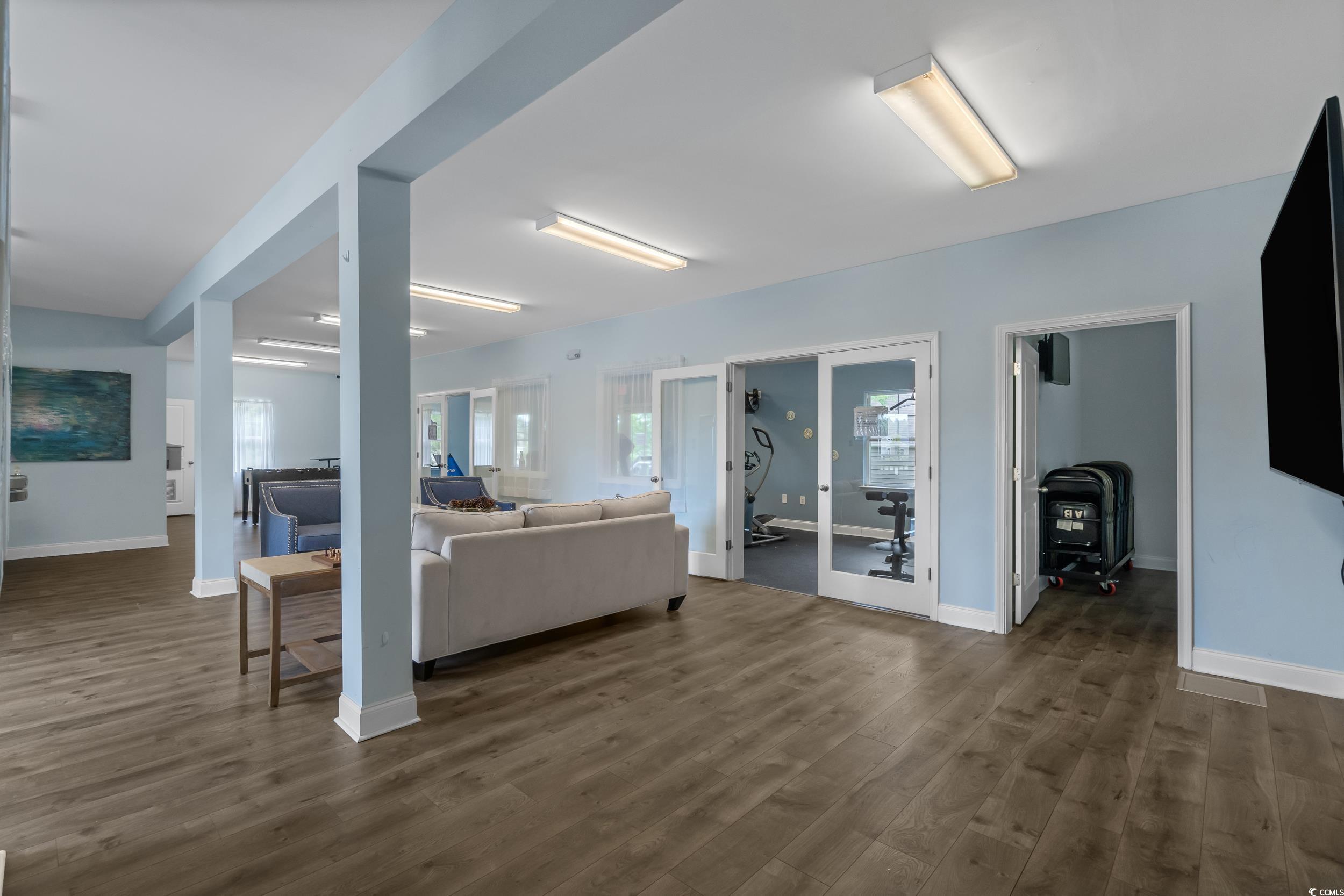 517 Mossbank Loop Longs, SC 29568 - Photo 36 of 40 Living area featuring dark wood-type flooring, french doors, and plenty of natural light