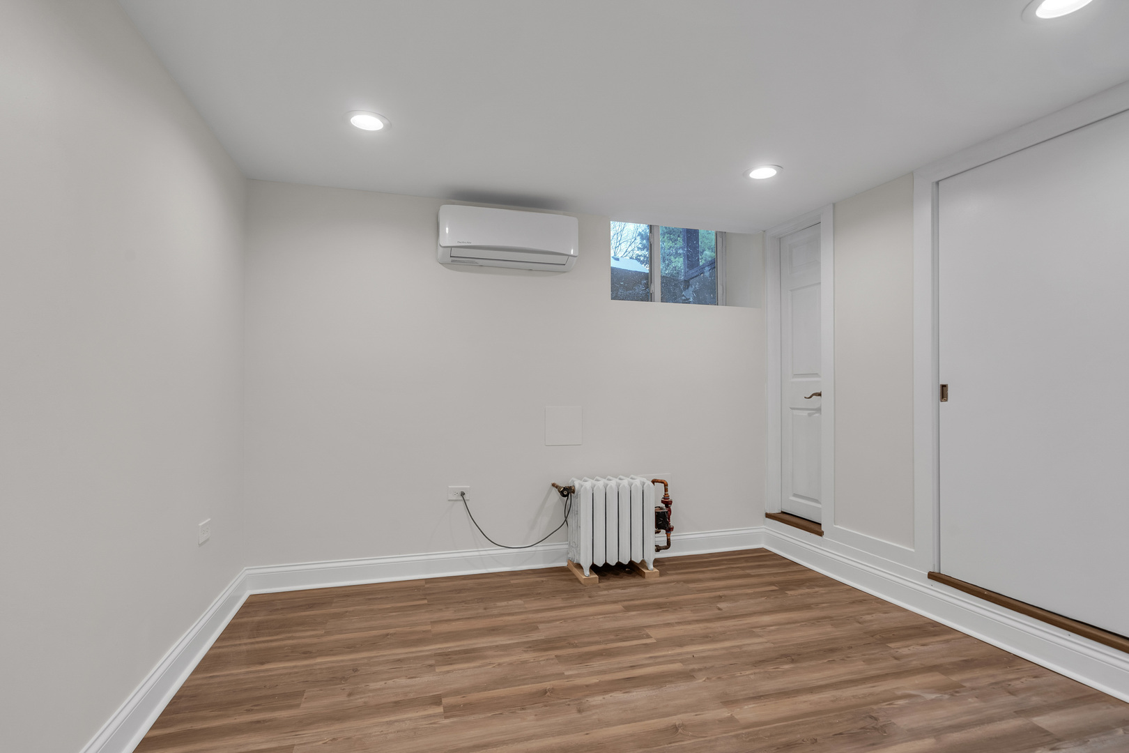 1155 St Johns Avenue, Unit H Highland Park, IL 60035 - Photo 13 of 20 a view of an empty room with wooden floor and a window