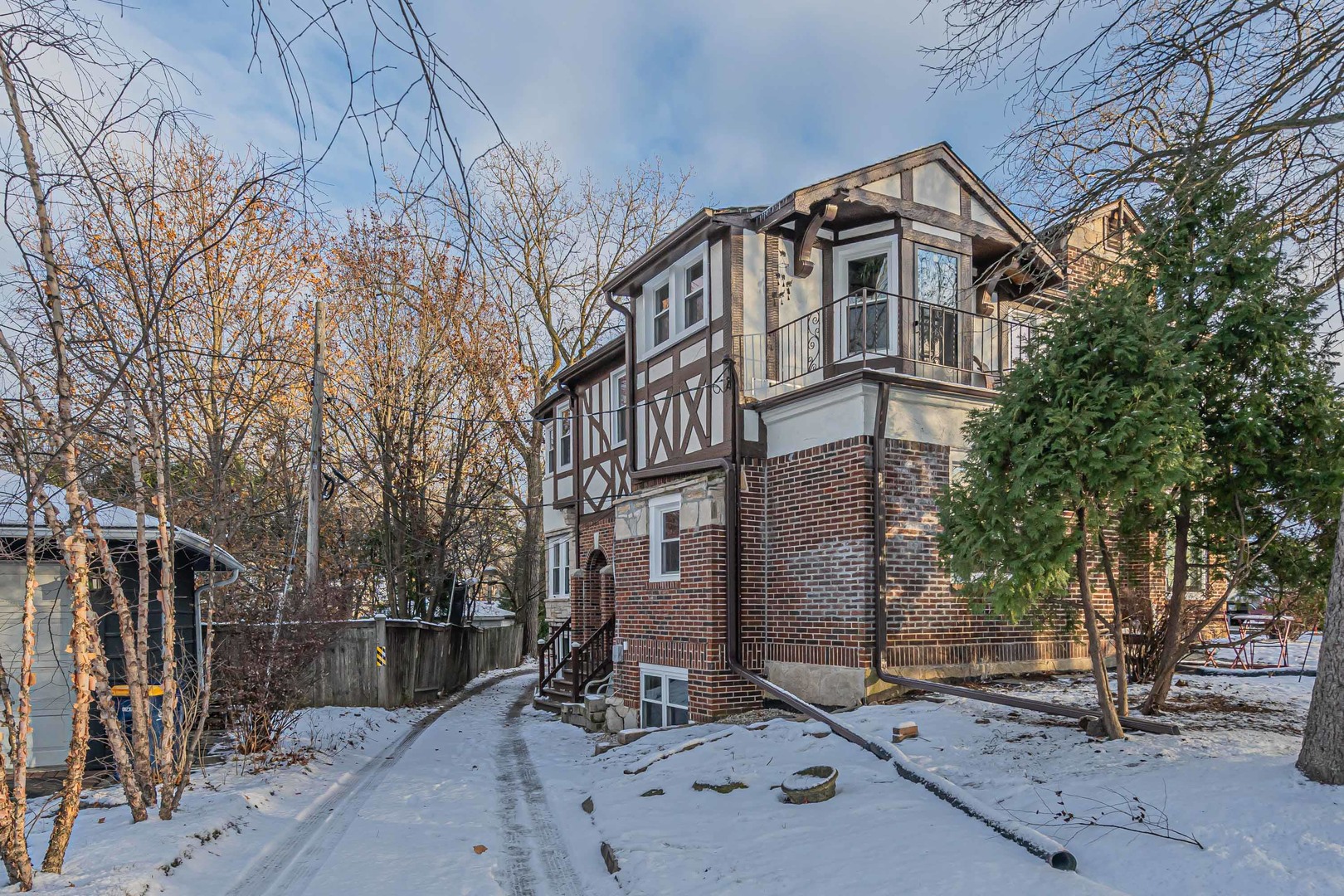 1155 St Johns Avenue, Unit H Highland Park, IL 60035 - Photo 18 of 20 a view of a brick house with large windows and wooden fence