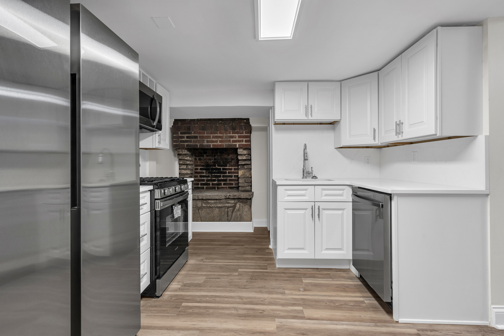 1155 St Johns Avenue, Unit H Highland Park, IL 60035 - Photo 4 of 20 a kitchen with stainless steel appliances a refrigerator stove and cabinets