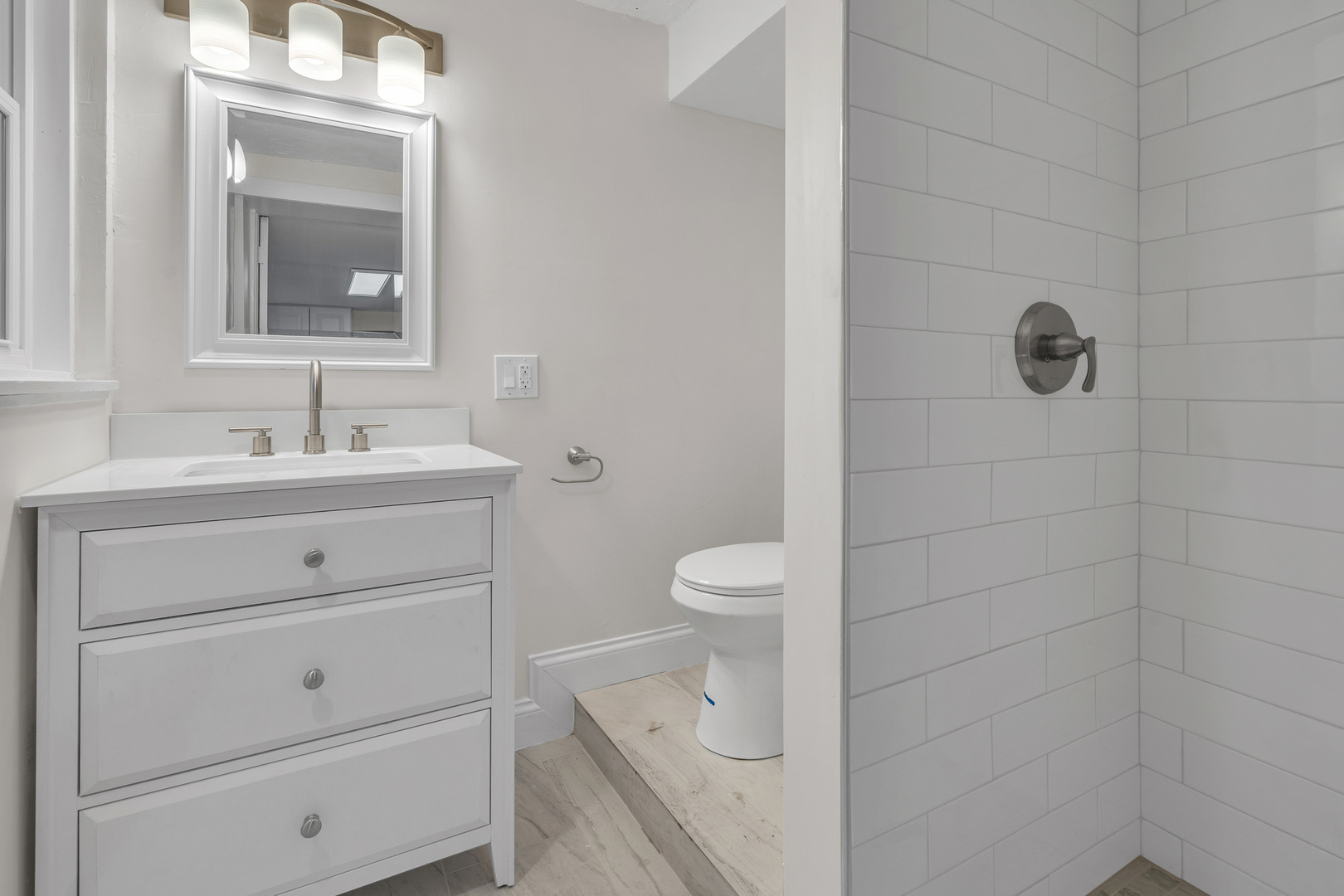 1155 St Johns Avenue, Unit H Highland Park, IL 60035 - Photo 6 of 20 a bathroom with a sink a toilet and mirror