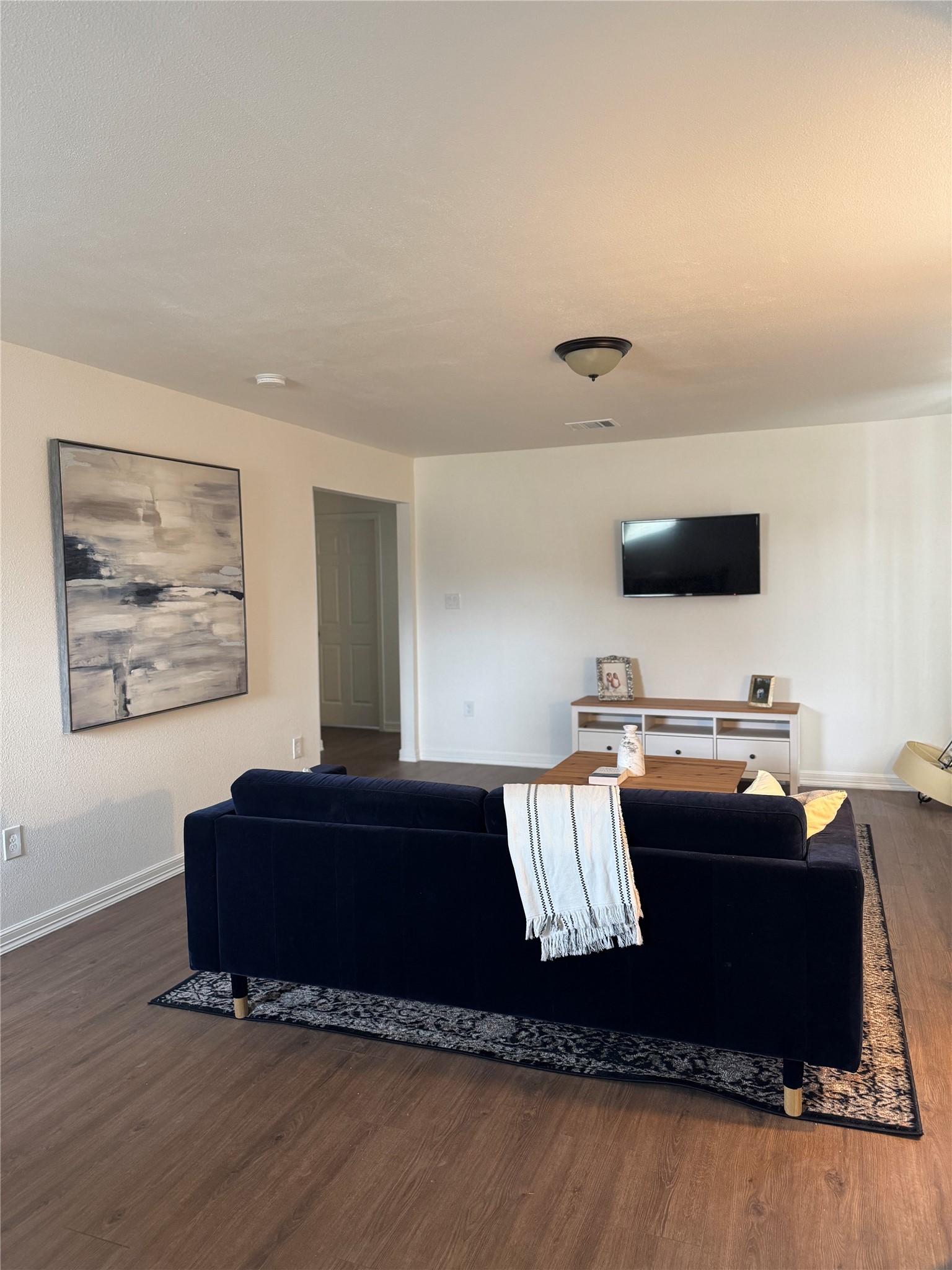 5607 Collins Road Houston, TX 77016 - Photo 4 of 9 a living room with furniture and a flat screen tv