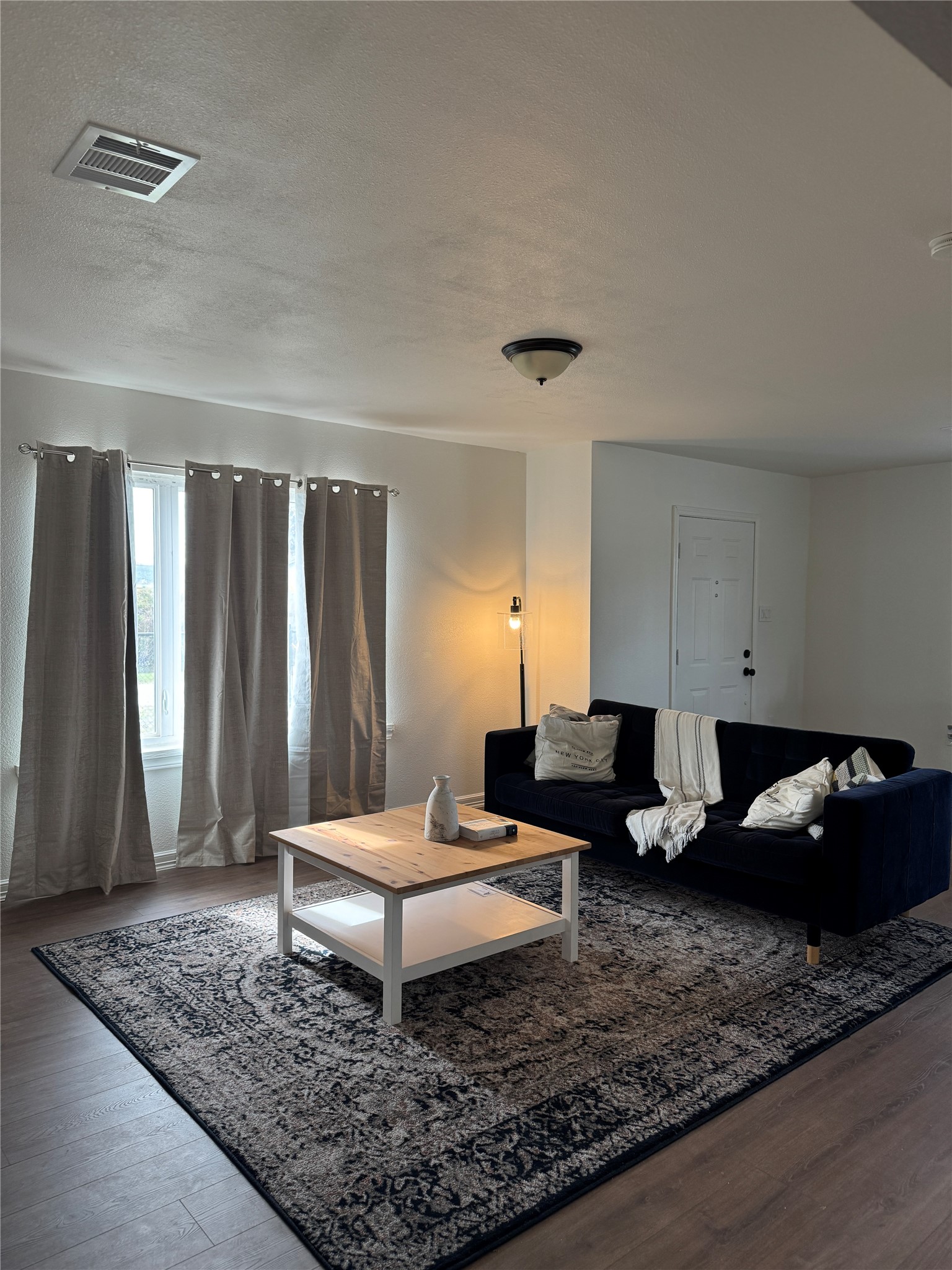 5607 Collins Road Houston, TX 77016 - Photo 5 of 9 a living room with furniture and a rug